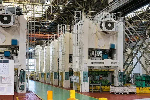 Metal stamping presses in a cold stamping workshop at an automobile plant. Production of car bodies